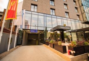 an entrance to a hotel with a flag and a building at Hotel Union in Podgorica