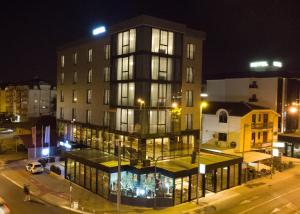 a building at night with lights on a street at Hotel Union in Podgorica