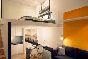 a living room with a loft bed and a desk at Cathedral Design Apartments in Porto