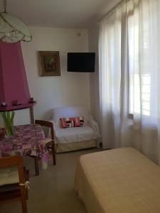 a room with a bed and a couch and a window at Relax da Sabry in Senigallia