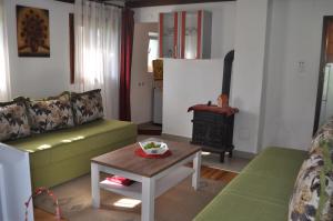 a living room with a couch and a stove at Apartment Enjoy in Kolašin