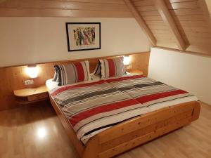 a bedroom with a wooden bed in a attic at Ranner's Ferienwohnung in Hermagor