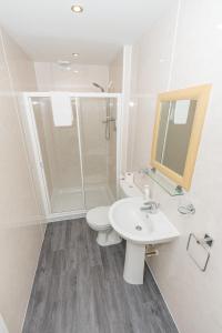 a bathroom with a toilet and a sink and a shower at Granite City Guest House in Aberdeen
