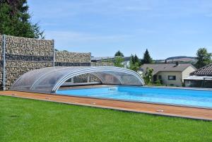 a swimming pool with a glass bridge over it at Ferienwohnung Jucarm in Sankt Wendel