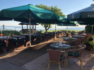 a restaurant with tables and chairs with umbrellas at Hotel Seiserhof & Seiseralm in Bernau am Chiemsee