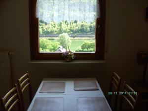 a table in a room with a window with a view at Moselblick in Sankt Aldegund
