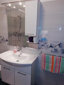 a white bathroom with a sink and a shower at App Dalia Losinj in Mali Lošinj +47 photos