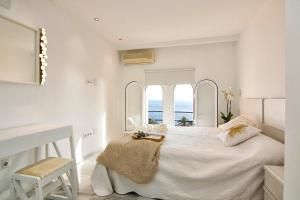 a white bedroom with a large bed and a desk at Duplex Penthouse with Swimming Pool in La Herradura +129 photos