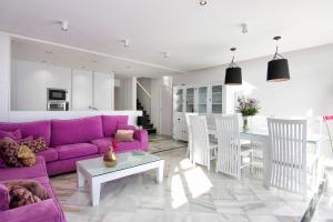 a living room with a purple couch and a table at Duplex Penthouse with Swimming Pool in La Herradura