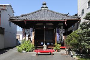 a red bench in front of a building at Konuka Yakushi Temple House in Kyoto