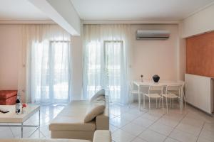 a living room with a couch and a table at Seaside House in Voula in Athens