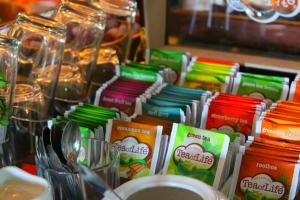 a table with a bunch of colorful packets of food at De Herbergh van Flielant in Oost-Vlieland