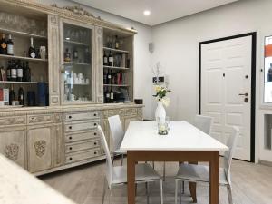 a dining room with a table and chairs and a cabinet at Bed and Breakfast Sun Wine in Taranto