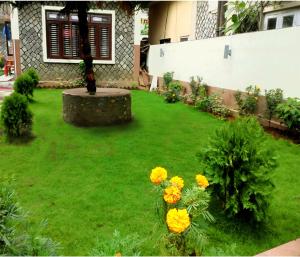 a yard with yellow flowers in the grass at Hotel Cordial in Pokhara
