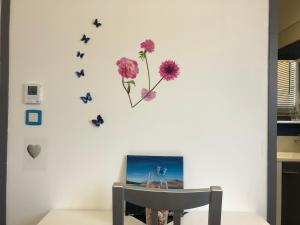 a wall with butterflies and flowers on it at La vallée des noyers in Beaulieu