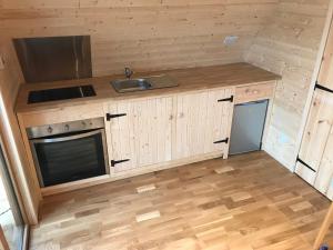 a small kitchen with a sink and a stove at Sutor Coops The Nest with Hot Tub in Cromarty +19 photos
