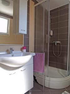 a bathroom with a sink and a shower at Federica A2+1 in Veli Lošinj