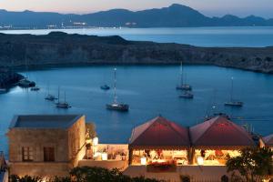 a view of a harbor with boats in the water at Melenos Art Boutique Hotel in Líndos