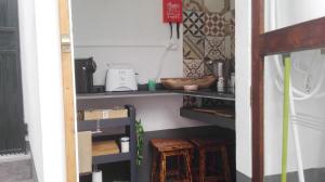 a room with a shelf with a blender and wooden stool at A Casa da Avó... in São Vicente +15 photos