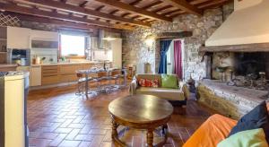 a living room with a couch and a table and a kitchen at Casa Mazzocchi Vista su Poppi in Poppi