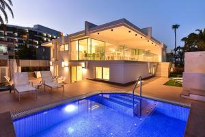 a house with a swimming pool in front of a house at Blue Ocean Villa Maspalomas in Maspalomas