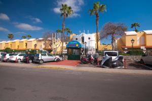 a parking lot with cars parked next to a street at Charming House in Maspalomas