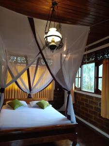 a bedroom with a bed with a mosquito net at Villa Mahalini Seminyak in Seminyak