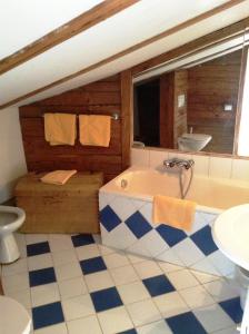 a bathroom with a tub and a toilet at Villa Mellon in Kitzbühel