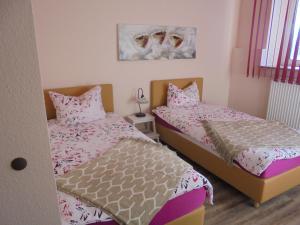 two beds in a small room with twoermottermottermott at Holstenhof"garni" in Schmalfeld