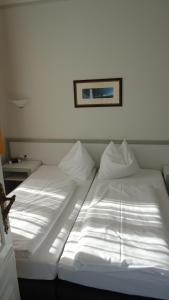 Een bed of bedden in een kamer bij Hotel Fortuna