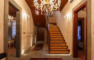 a hallway with a staircase with a chandelier at Verula City Luxury Villa in Trabzon