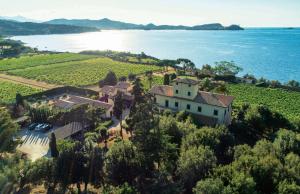 an aerial view of a house on a hill next to the water at Tenuta La Chiusa in Portoferraio