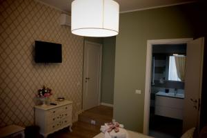 a room with a bedroom with a white dresser and a lamp at Allaportaccanto Bed & Breakfast in Cassino +22 photos