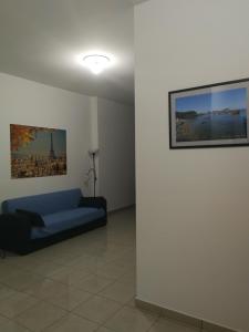 a room with a blue bed and a painting on the wall at Confortable Apartment in Vasto in Vasto