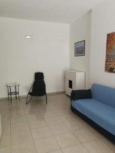 a living room with a blue couch and a table at Confortable Apartment in Vasto in Vasto