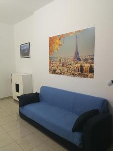 a blue couch in a living room with the eiffel tower at Confortable Apartment in Vasto in Vasto