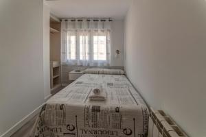 a bedroom with two beds and a window at Hostal Lar in Burgos
