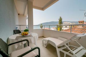 a balcony with a table and chairs and a view at Apartment Stella Maris in Herceg-Novi