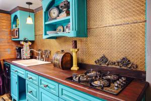 a kitchen with blue cabinets and a stove top at The Relic in Amarillo