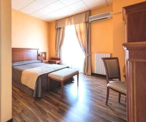 Postel nebo postele na pokoji v ubytování Hotel Maderno