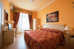 Postel nebo postele na pokoji v ubytování Hotel Maderno