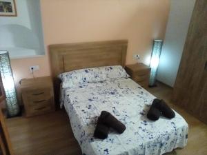 Un dormitorio con una cama con zapatos. en Apartament turístic Cal Mases , Camarasa, en Camarasa