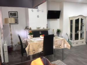 a dining room with a table and a fireplace at Casa Freixedelo in Santa Comba de Rossas