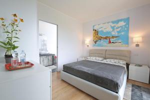a bedroom with a bed and a painting on the wall at Cà Stagia holiday house with private swimming-pool in Bellagio +27 photos