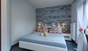 a bedroom with a bed and a brick wall at studio Anulka in Zakopane