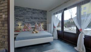 a bedroom with a bed and a large window at studio Anulka in Zakopane