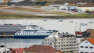 a cruise ship is docked in a harbor at Cilene del Faro Suites & Spa in Ushuaia