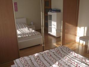 a bedroom with two beds and a mirror at Adoria in Giżycko