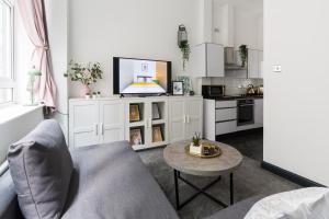 a living room with a couch and a table at The Birmingham Manhattan - Urban Living in Birmingham