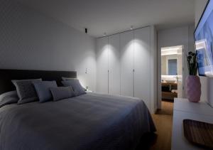 a bedroom with a large bed and a bathroom at Francisco Silvela Apartment by Flatsweethome in Madrid